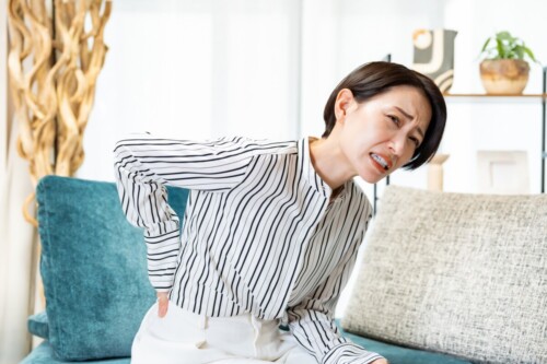 腰痛に悩む女性の姿